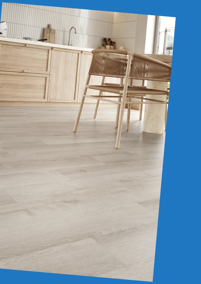 Light vinyl plank flooring running through a kitchen with pale wood cabinetry